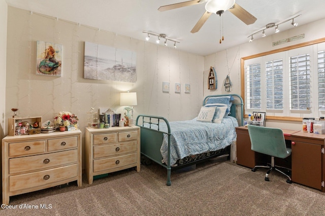 carpeted bedroom featuring rail lighting and ceiling fan