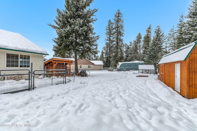 snowy yard with an outbuilding