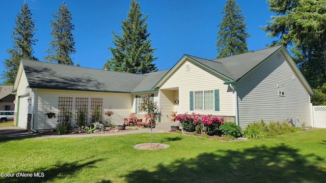 view of front of home featuring a garage and a front lawn