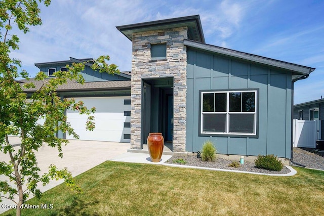 7257 Breaux Dr, Coeur Dalene, ID 83815 - modern home featuring stone siding, board and batten siding, driveway, and a garage