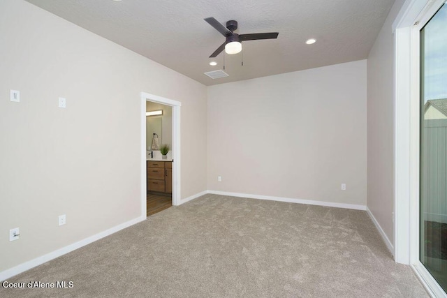 7257 Breaux Dr, Coeur Dalene, ID 83815 - unfurnished bedroom featuring carpet, recessed lighting, baseboards, connected bathroom, and a ceiling fan