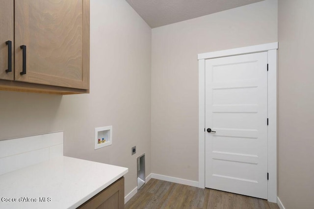 7257 Breaux Dr, Coeur Dalene, ID 83815 - laundry area featuring cabinet space, washer hookup, electric dryer hookup, wood finished floors, and baseboards