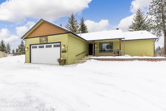 ranch-style house with a garage and covered porch