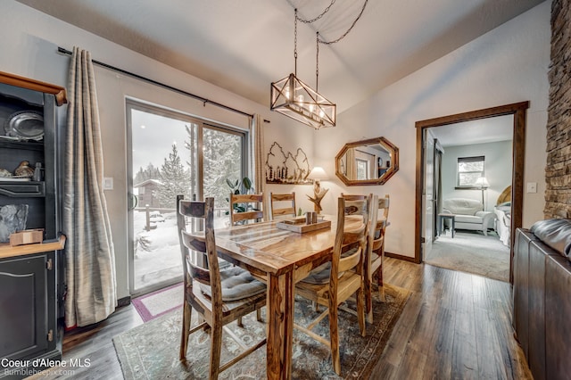 dining room featuring wood-type flooring and vaulted ceiling