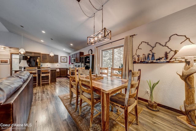 dining room featuring lofted ceiling and wood-type flooring