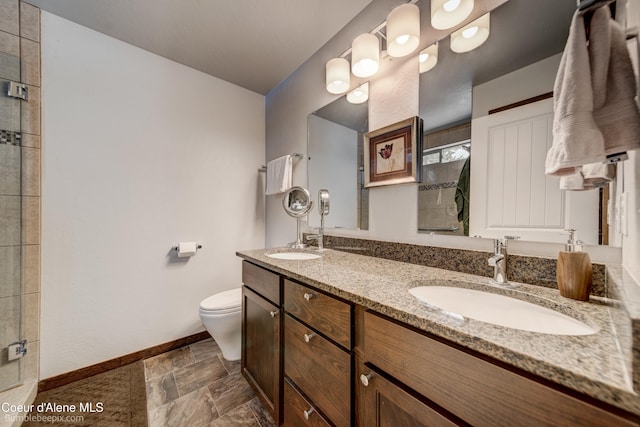 bathroom with toilet, vanity, and walk in shower