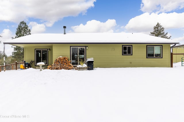 view of snow covered rear of property