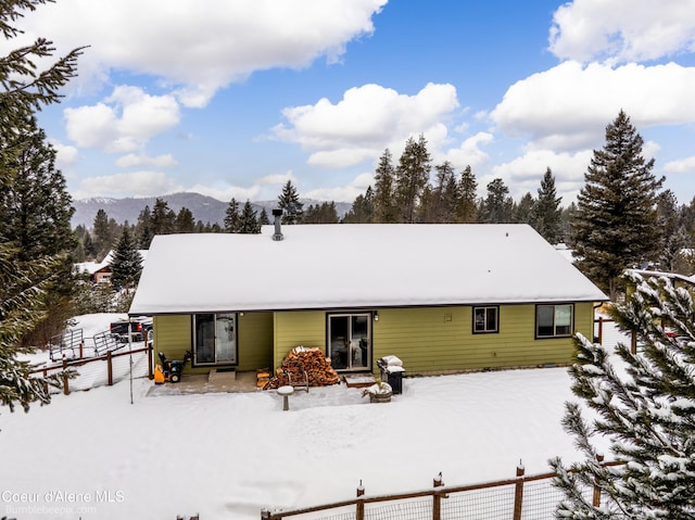 snow covered house with a mountain view