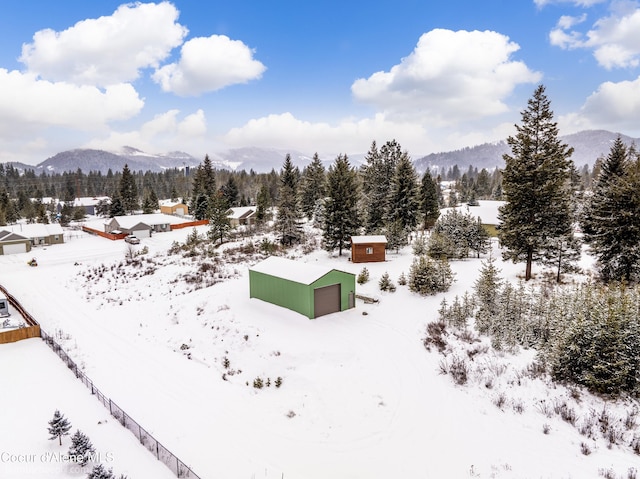 snowy aerial view with a mountain view