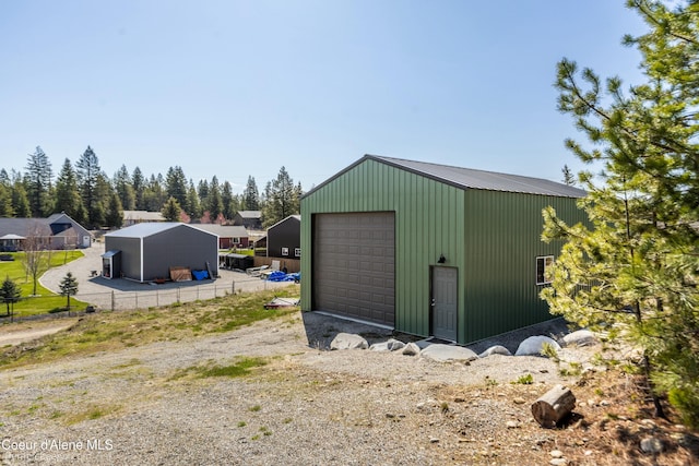 view of outbuilding featuring fence and an outdoor structure