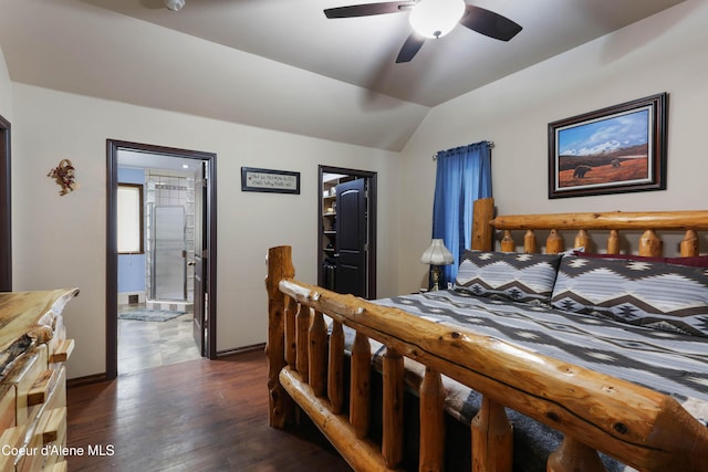 bedroom with lofted ceiling, dark wood-type flooring, connected bathroom, and ceiling fan