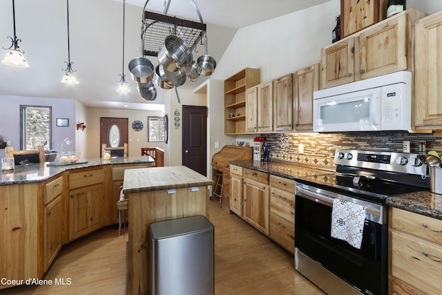 kitchen featuring pendant lighting, stainless steel electric range oven, a kitchen island, and dark stone counters