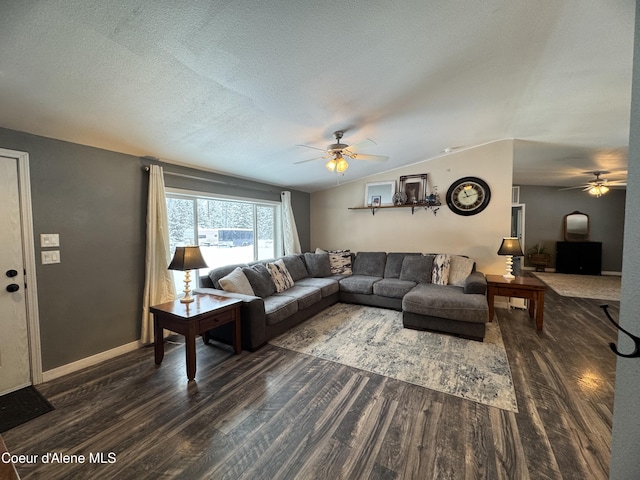 living room featuring lofted ceiling, ceiling fan, dark hardwood / wood-style floors, and a textured ceiling