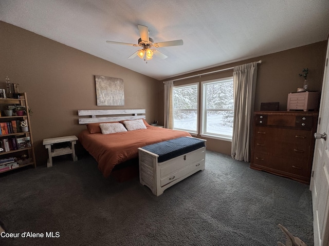 bedroom with dark colored carpet, lofted ceiling, and ceiling fan