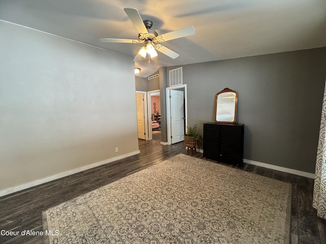 unfurnished bedroom featuring ceiling fan, lofted ceiling, and dark hardwood / wood-style floors