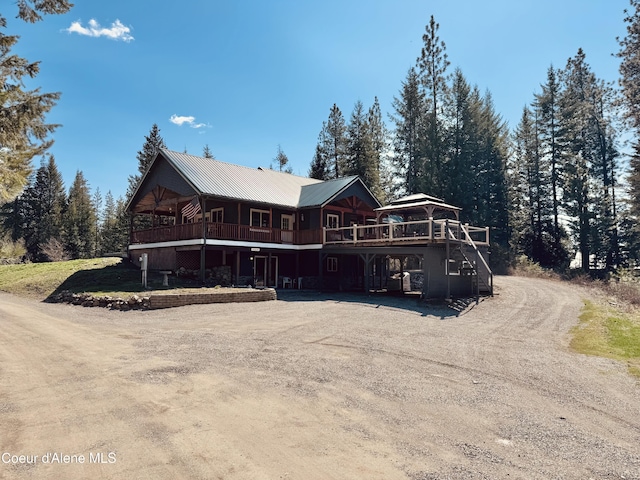 4058 W Seasons Rd, Rathdrum, ID 83858 - view of front facade with metal roof, driveway, and a wooden deck