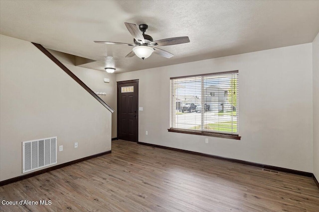 13043 N Zodiac Loop, Rathdrum, ID 83858 - entryway with wood finished floors, baseboards, ceiling fan, and a textured ceiling