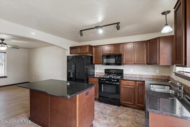 13043 N Zodiac Loop, Rathdrum, ID 83858 - kitchen with black appliances, a ceiling fan, a sink, a center island, and pendant lighting