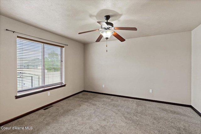 13043 N Zodiac Loop, Rathdrum, ID 83858 - empty room with carpet flooring, baseboards, a ceiling fan, and a textured ceiling