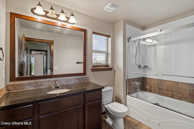 13043 N Zodiac Loop, Rathdrum, ID 83858 - bathroom with toilet, vanity, and bath / shower combo with glass door
