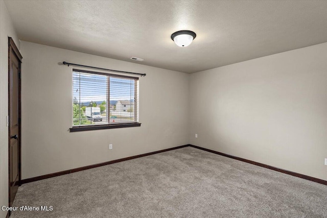 13043 N Zodiac Loop, Rathdrum, ID 83858 - empty room featuring carpet flooring, baseboards, and a textured ceiling