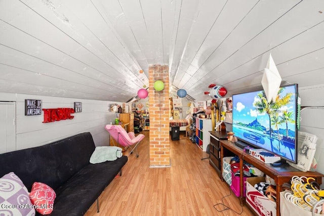 playroom with vaulted ceiling, wooden ceiling, light wood-type flooring, and wood walls