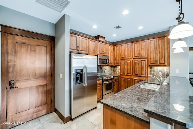 kitchen with light tile patterned flooring, pendant lighting, sink, kitchen peninsula, and stainless steel appliances