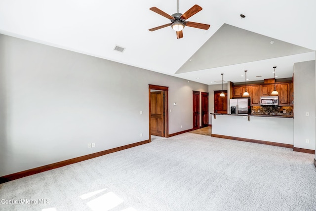 unfurnished living room featuring high vaulted ceiling, light colored carpet, and ceiling fan