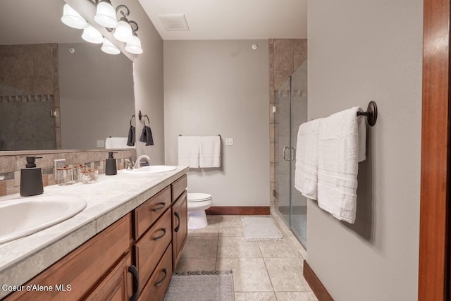 bathroom featuring vanity, an enclosed shower, tile patterned flooring, and toilet