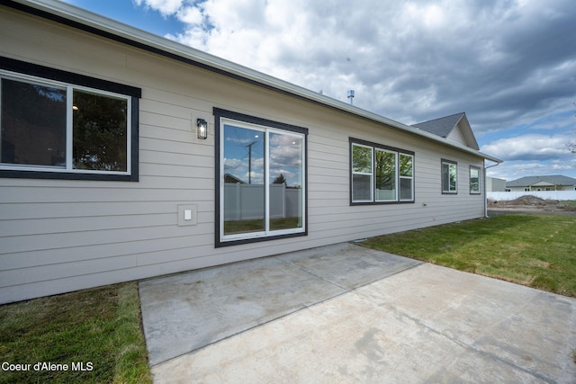 1225 W Orchard Ave, Hayden, ID 83835 - view of side of home with a yard and a patio