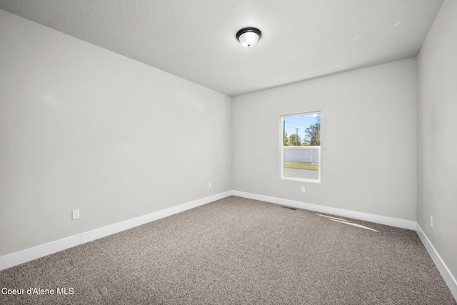 1225 W Orchard Ave, Hayden, ID 83835 - carpeted empty room with baseboards