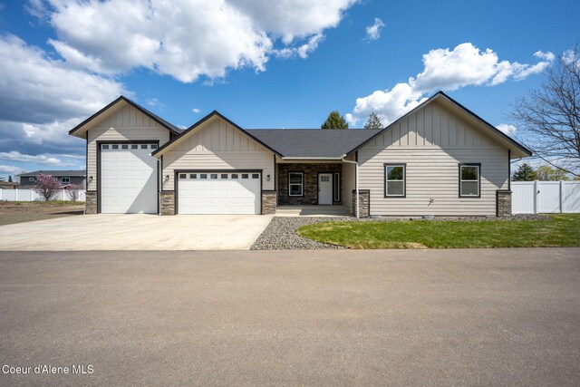 1225 W Orchard Ave, Hayden, ID 83835 - ranch-style house featuring fence, board and batten siding, driveway, stone siding, and a garage