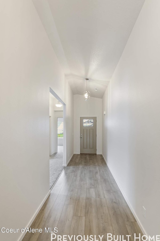 entryway with wood finished floors and baseboards