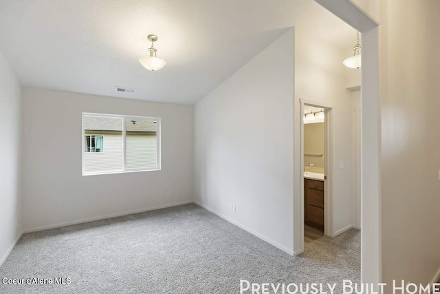 unfurnished room with light carpet, visible vents, and baseboards