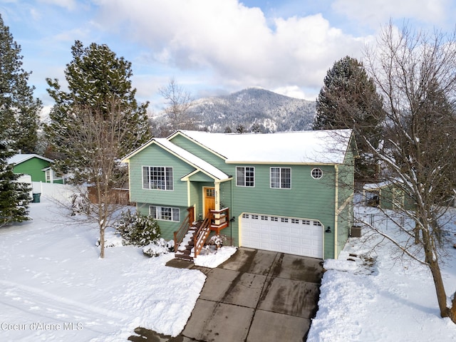 raised ranch with a mountain view and a garage