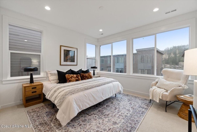 carpeted bedroom featuring multiple windows