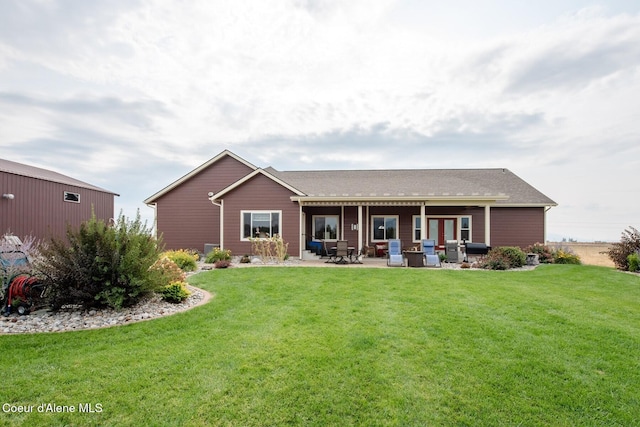 rear view of house featuring a yard and a patio area