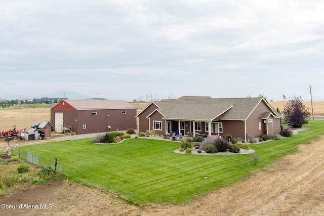 view of front facade featuring a pole building, an outdoor structure, and a front lawn