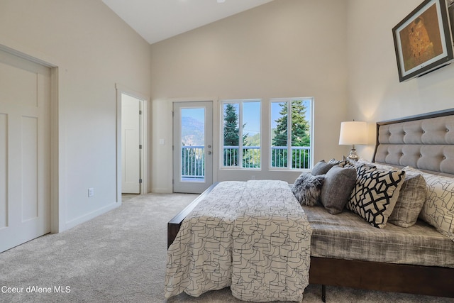 bedroom featuring light colored carpet, access to exterior, and high vaulted ceiling