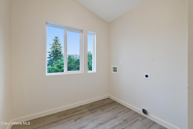 laundry room with hookup for a washing machine, hookup for an electric dryer, and light wood-type flooring