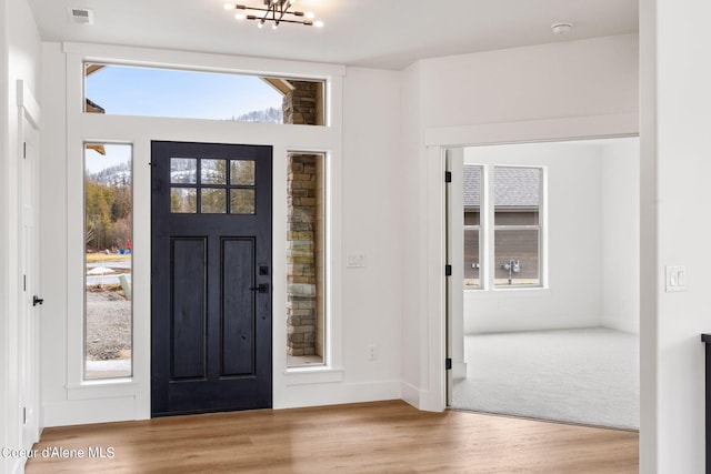 entryway featuring a notable chandelier and light hardwood / wood-style flooring