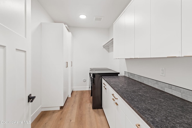 kitchen with light hardwood / wood-style floors and white cabinets