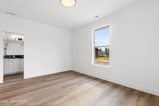 unfurnished room with light hardwood / wood-style flooring