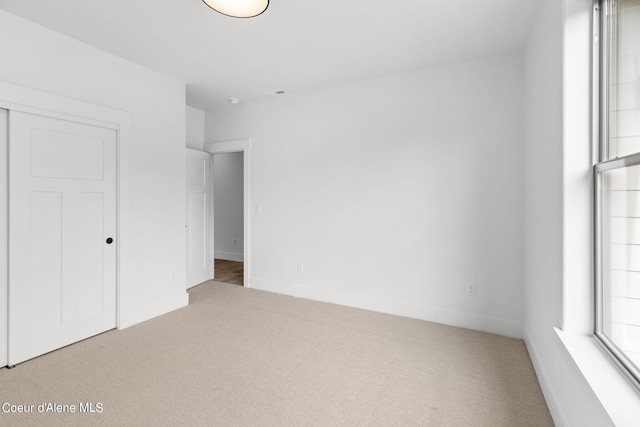 unfurnished bedroom with carpet flooring and a closet