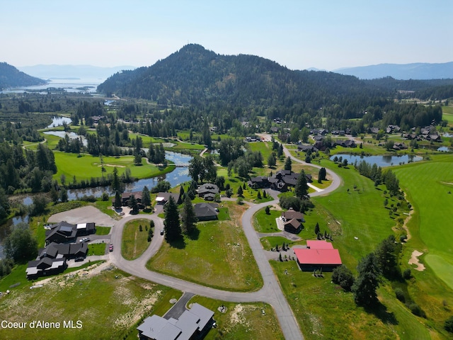 drone / aerial view featuring a water and mountain view