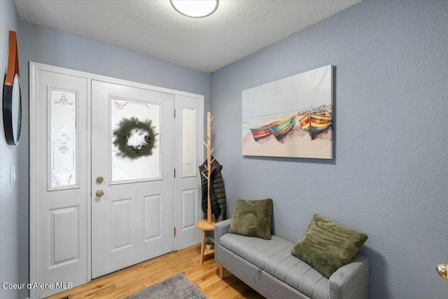 entrance foyer featuring a textured ceiling and light hardwood / wood-style flooring