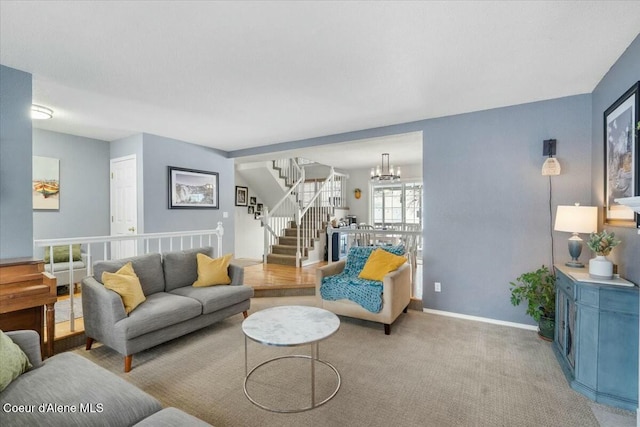 carpeted living room with a notable chandelier