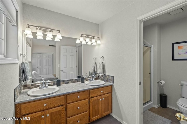 bathroom with tile patterned flooring, vanity, an enclosed shower, and toilet