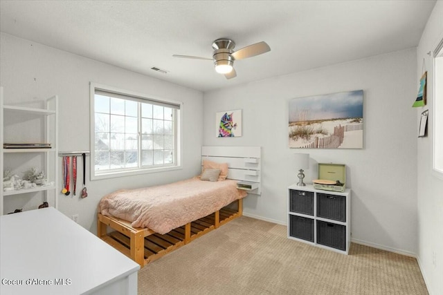 bedroom featuring light carpet and ceiling fan