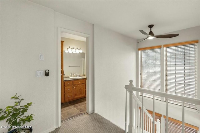 hall with light carpet and sink